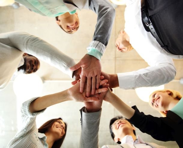 business people teamwork in an office with hands together